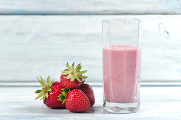 Traditional ayurvedic healthy drink with strawberries of yogurt and ice cube with drinking