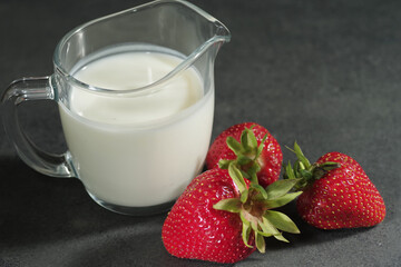 Traditional ayurvedic healthy drink with strawberries of yogurt and ice cube with drinking