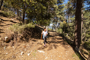 Fototapeta premium A middle-aged Caucasian woman hiking in the Sierra de Cazorla. Concept of the lifestyle of middle-aged people.