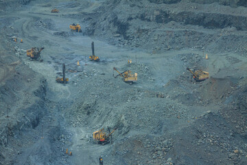 The work of large equipment for open-pit mining of iron ore. Drill rigs and excavators in the...