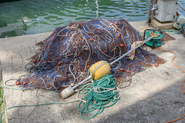 Tangled pile of fishing nets laying on dock
