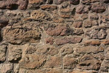 Wall made of reddish stones of irregular form