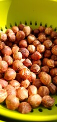 Peeled nuts lie in a colander. Hazelnut. Proper nutrition, healthy nutrition. Focus in the center of the frame.