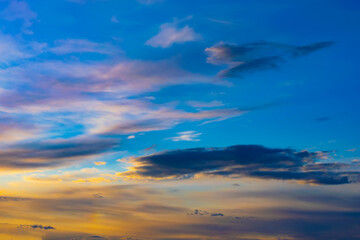 sunset of the yellow sun in a blue sky with rain clouds
