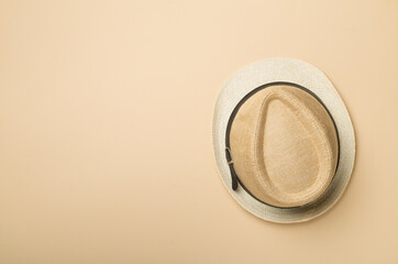 Straw hat on color background, top view