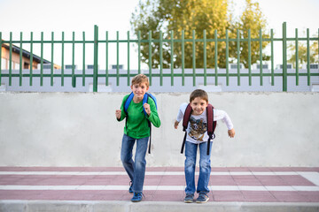 Two children get ready to run towards the camera. Back to school concept