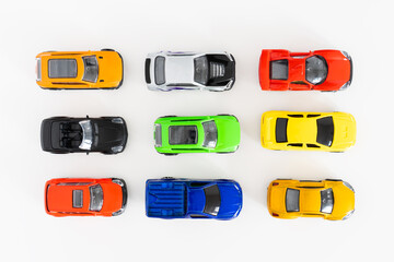 Colorful toy cars on white background, close up, top view.