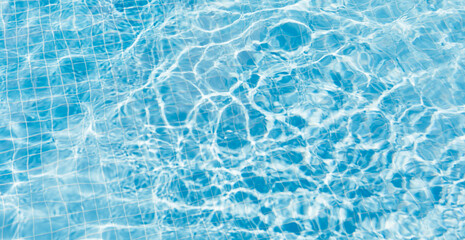 Obraz na płótnie Canvas Clear water surface with ripple wave splashes and drops in swimming pool. Abstract turquoise or blue texture water wave and sunlight shadow reflections for background. Banner.