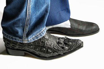 Different leather men's pair of shoes and pants on a white background.
