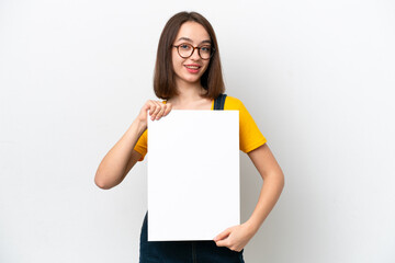 Young Ukrainian woman isolated on white background holding an empty placard with happy expression