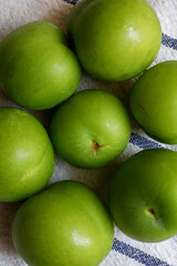 top view green plums  on the table

