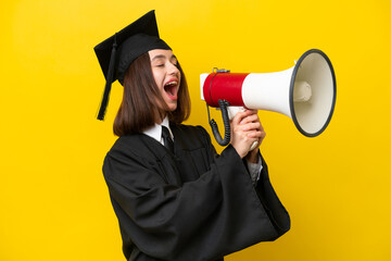 Young university graduate Ukrainian woman isolated on yellow background shouting through a megaphone