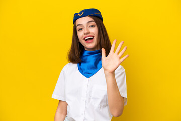 Airplane stewardess Ukrainian woman isolated on yellow background counting five with fingers