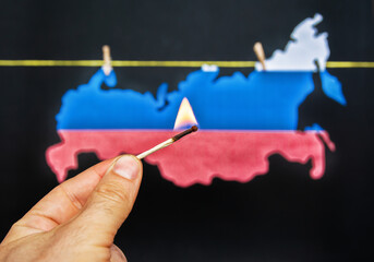map of Russia burning match - as a symbol of incitement to crisis and chaos of division in country and and forest fires