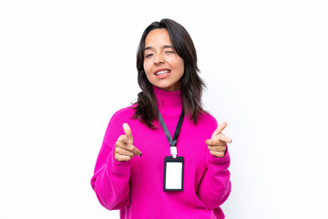 Young hispanic woman with ID card isolated on white background pointing to the front and smiling