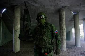 Fototapeta premium Russian military soldier in uniform holding up his weapon