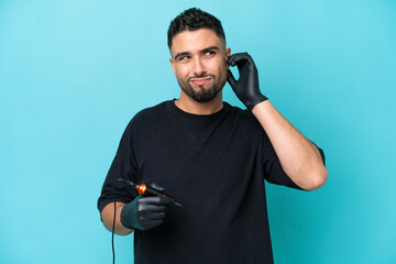 Tattooist Arab man isolated on blue background frustrated and covering ears