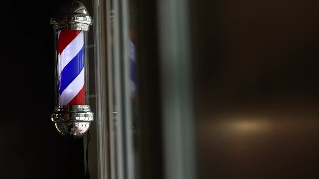 Barber shop vintage pole. copyspace Barbershop. Barber shop pole in red white and blue with lightbulb on top