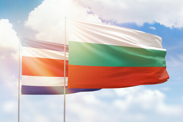 Sunny blue sky and flags of bulgaria and costa rica