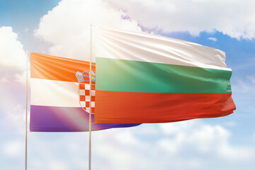 Sunny blue sky and flags of bulgaria and croatia