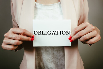 Businesswoman holding sheet of paper with text obligation. Business responsibility, financial concept