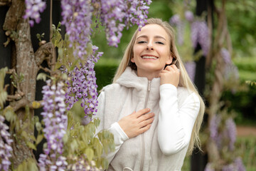 Portrait of a girl in blooming wisteria