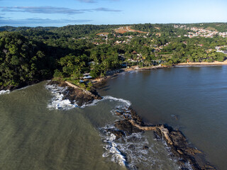 Fototapeta na wymiar Aerial drone view of rocks separating the sea from the river in a coastal city