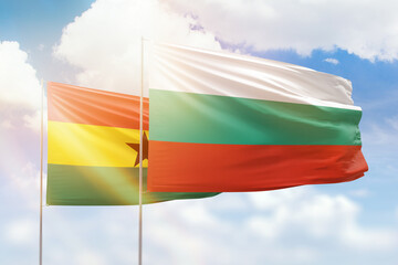 Sunny blue sky and flags of bulgaria and ghana