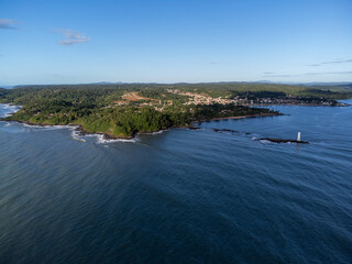 Panoramic view of coastal city with lighthouse dividing river and sea - Itacaré, Bahia, Brazil