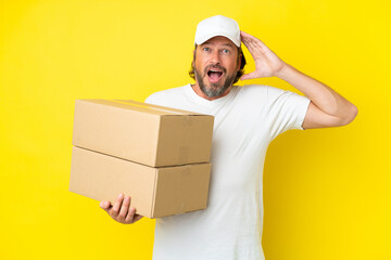 Delivery senior dutch man isolated on yellow background with surprise expression