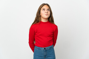Obraz premium Little girl over isolated white background and looking up