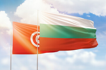 Sunny blue sky and flags of bulgaria and tunisia