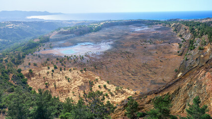 Fototapeta na wymiar Ecosystem restoration. Aerial panorama of backfilled open pit Limni copper mine near Polis, Cyprus