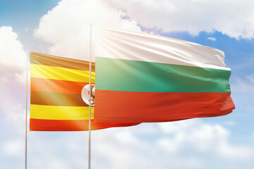 Sunny blue sky and flags of bulgaria and uganda
