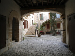 Spanish colonial style patio with stairs, plants and two floors. © Gustavo