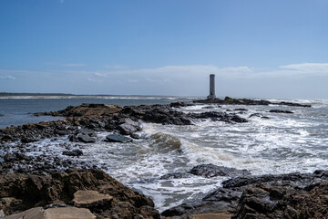 Fototapeta na wymiar Maritime lighthouse on beautiful beach crossing with river - Itacaré, Bahia, Brazil