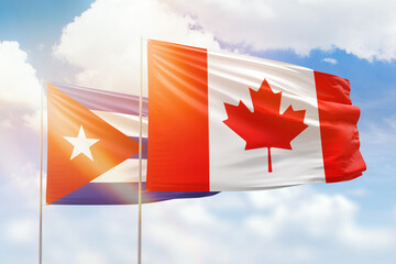 Sunny blue sky and flags of canada and cuba