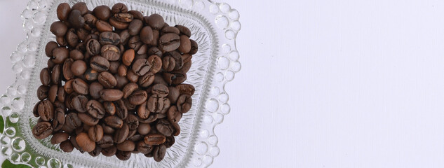 Close up of a glass plate filled with coffee beans