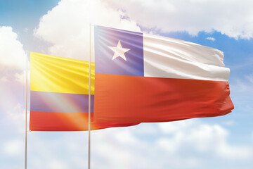 Sunny blue sky and flags of chile and colombia