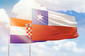 Sunny blue sky and flags of chile and croatia