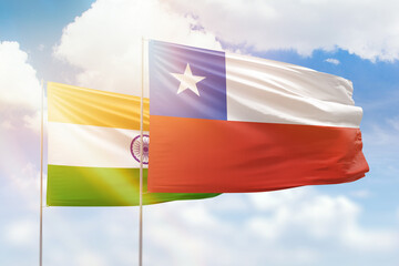 Sunny blue sky and flags of chile and india
