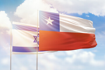 Sunny blue sky and flags of chile and israel