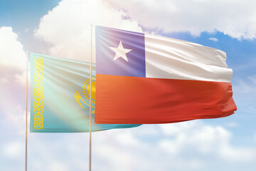 Sunny blue sky and flags of chile and kazakhstan