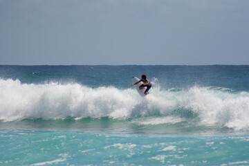 Surfer Mastering a Wave in White Surf