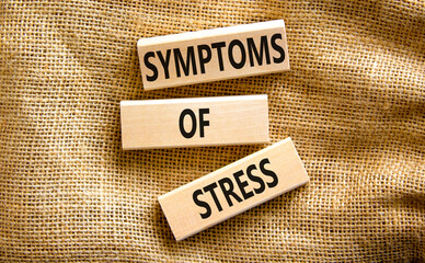 Symptoms of stress symbol. Concept words Symptoms of stress on wooden blocks. Beautiful canvas table canvas background. Psychological business and Symptoms of stress concept. Copy space.