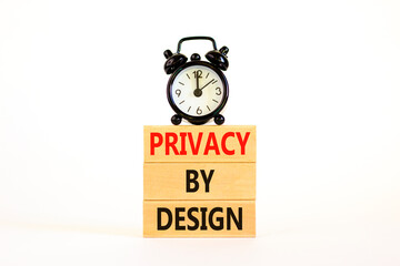 Privacy by design symbol. Concept words Privacy by design on wooden blocks on a beautiful white table white background. Black alarm clock. Business, finacial and privacy by design concept. Copy space.