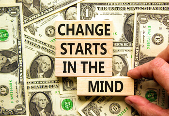 Change starts in the mind symbol. Concept words Change starts in the mind on wooden blocks on a beautiful background from dollar bills. Business, motivational and change starts in the mind concept.