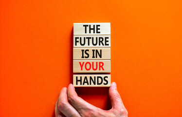 The future is in your hands symbol. Concept words The future is in your hands on wooden blocks on a beautiful orange table orange background. Businessman hand. Business future in your hands concept.