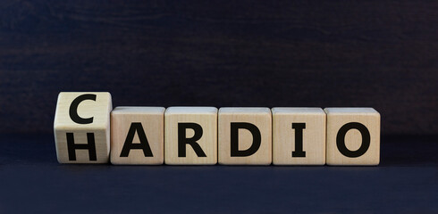 Cardio or hardio symbol. Turned wooden cubes and changed concept words hardio nto cardio. Beautiful black table black background. Sport, healthy lifestyle and cardio or hardio concept. Copy space.