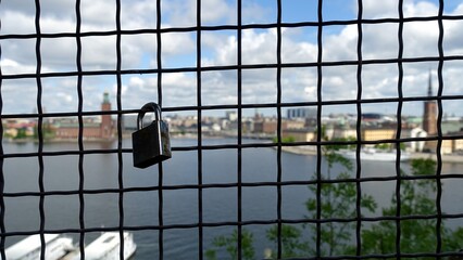 Love padlocks on a wire mesh during a scenic walk in a Stockholm street in Sweden.